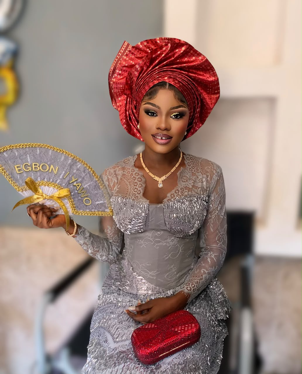 Red gele with silver lace and hand fan