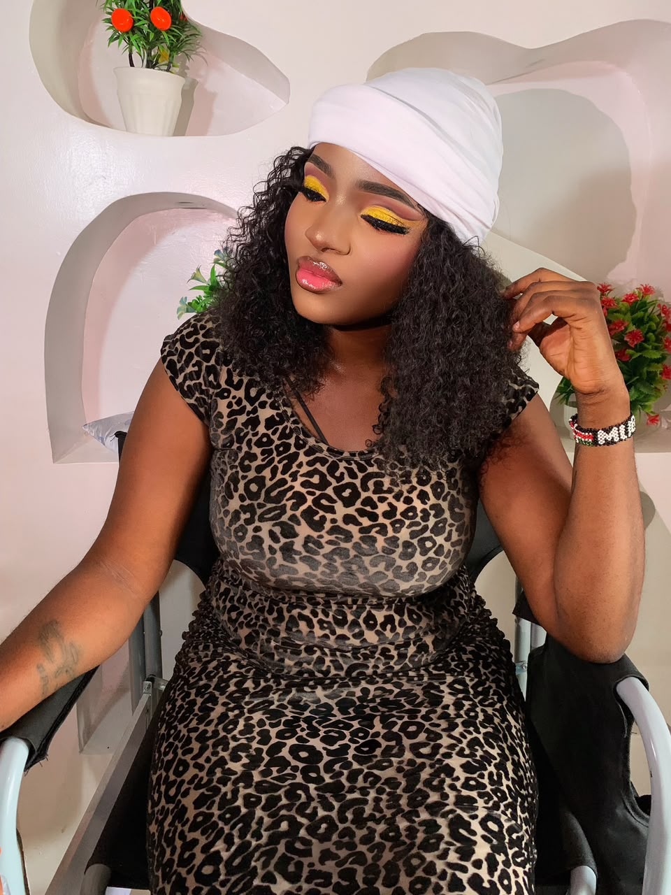 Yellow eye art with curls and white headwrap